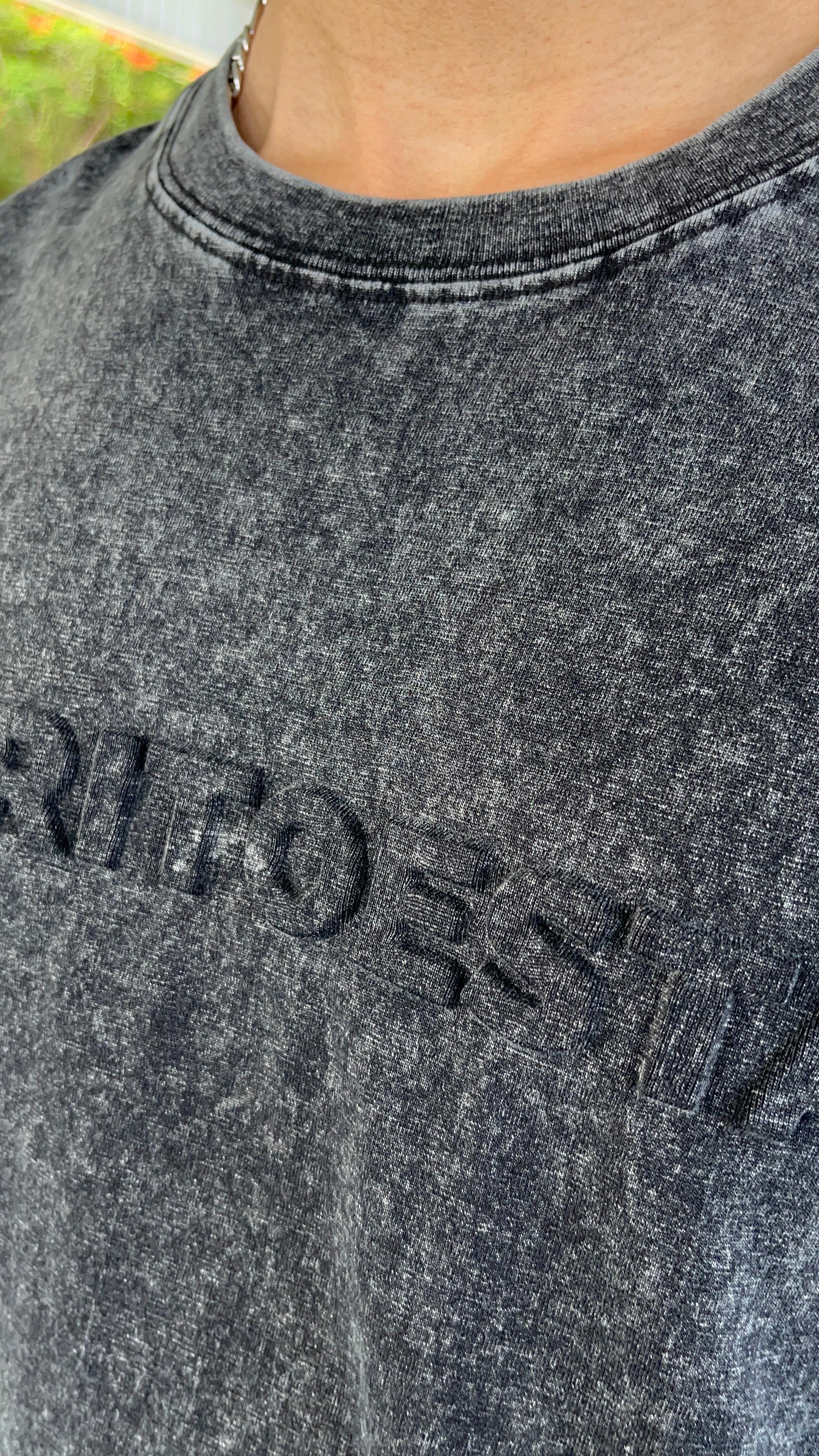 Close-up of a dark gray sweatshirt with 'Retro' text on a blurred background