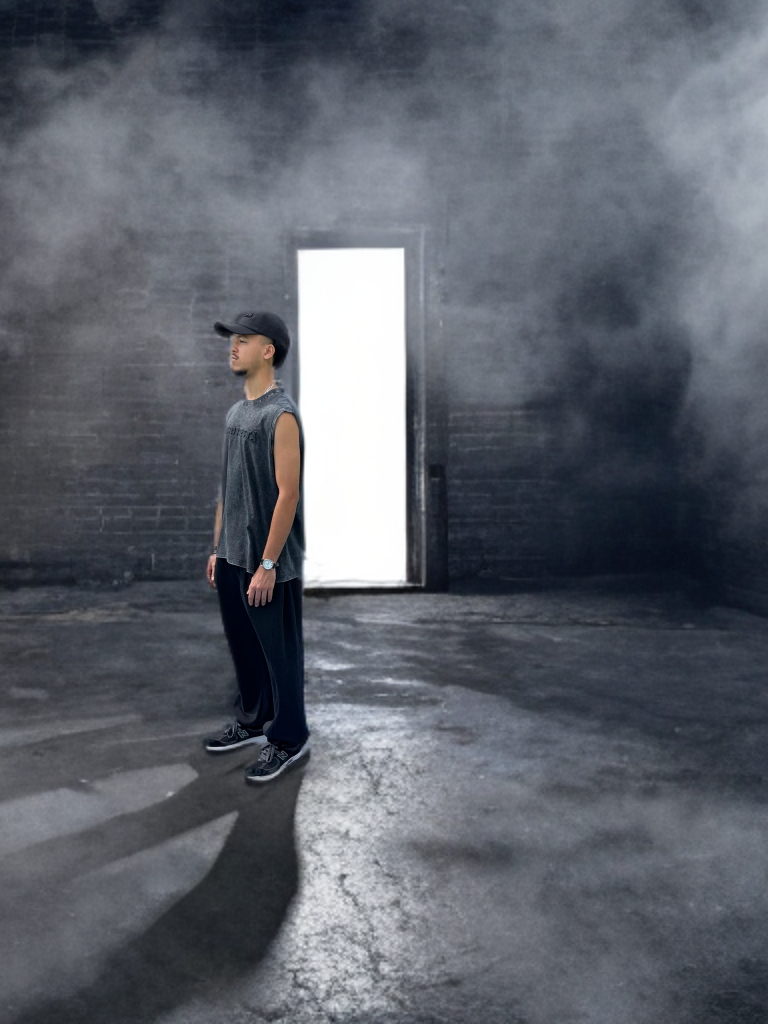 Person standing in a dark room with a bright light source creating a strong contrast